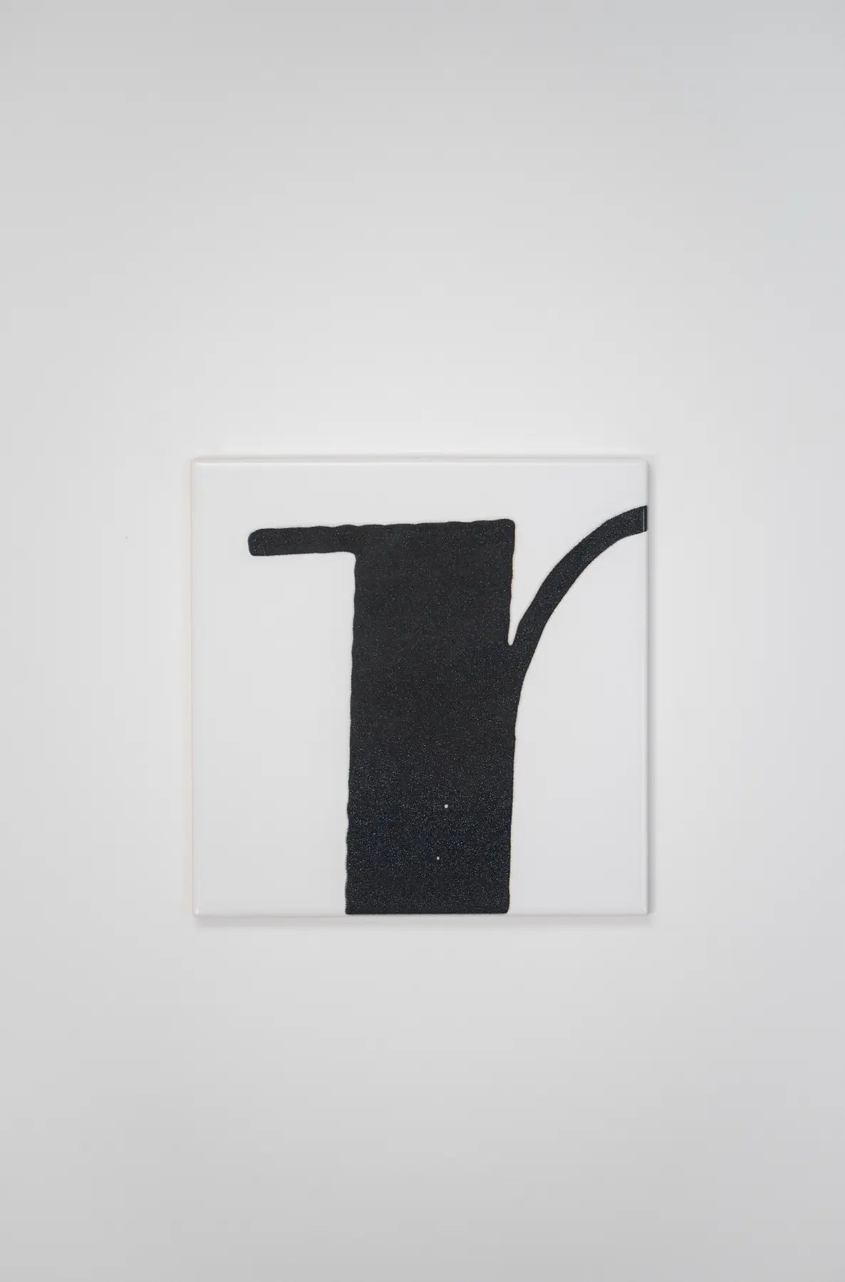 Pattern VHILS ceramic tile by Clay featuring bold black letter design – on sale at Clay