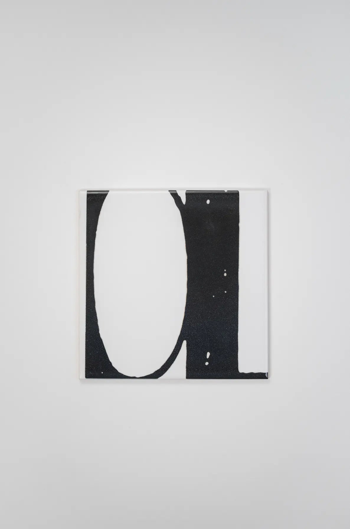 Pattern VHILS ceramic tile by Clay featuring large black letter on white – on sale now at Clay